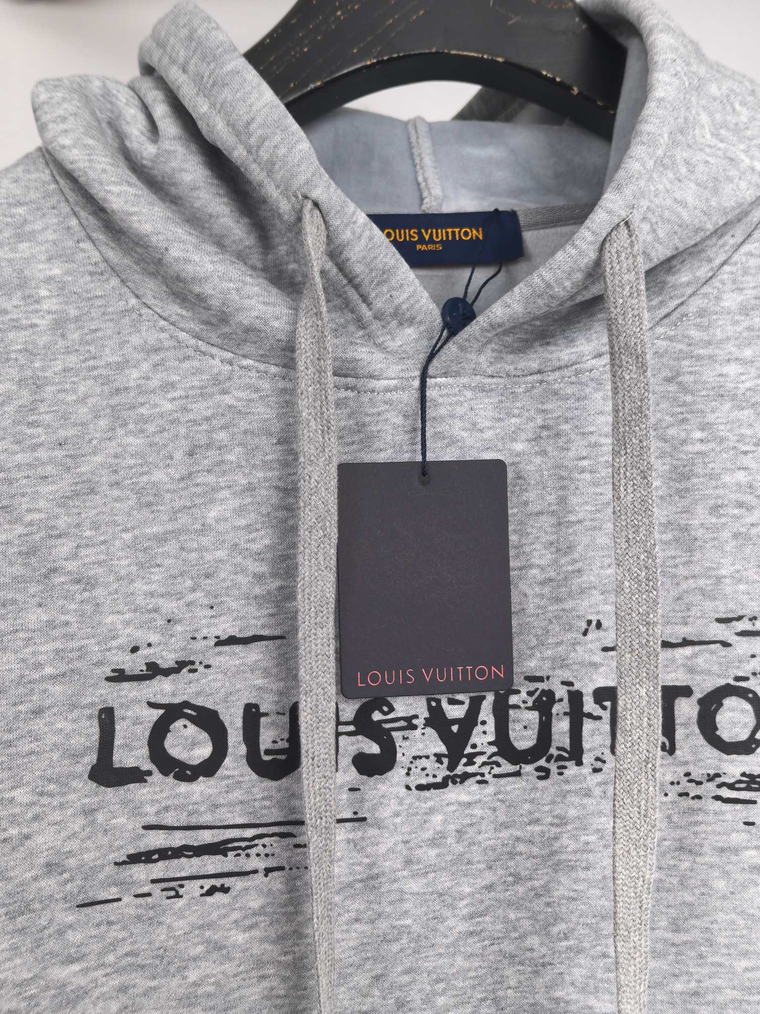 Heather gray hoodie with drawstring hood and black LV-style logo