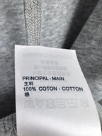 Clothing care label showing 100% cotton and Principal-Main text
