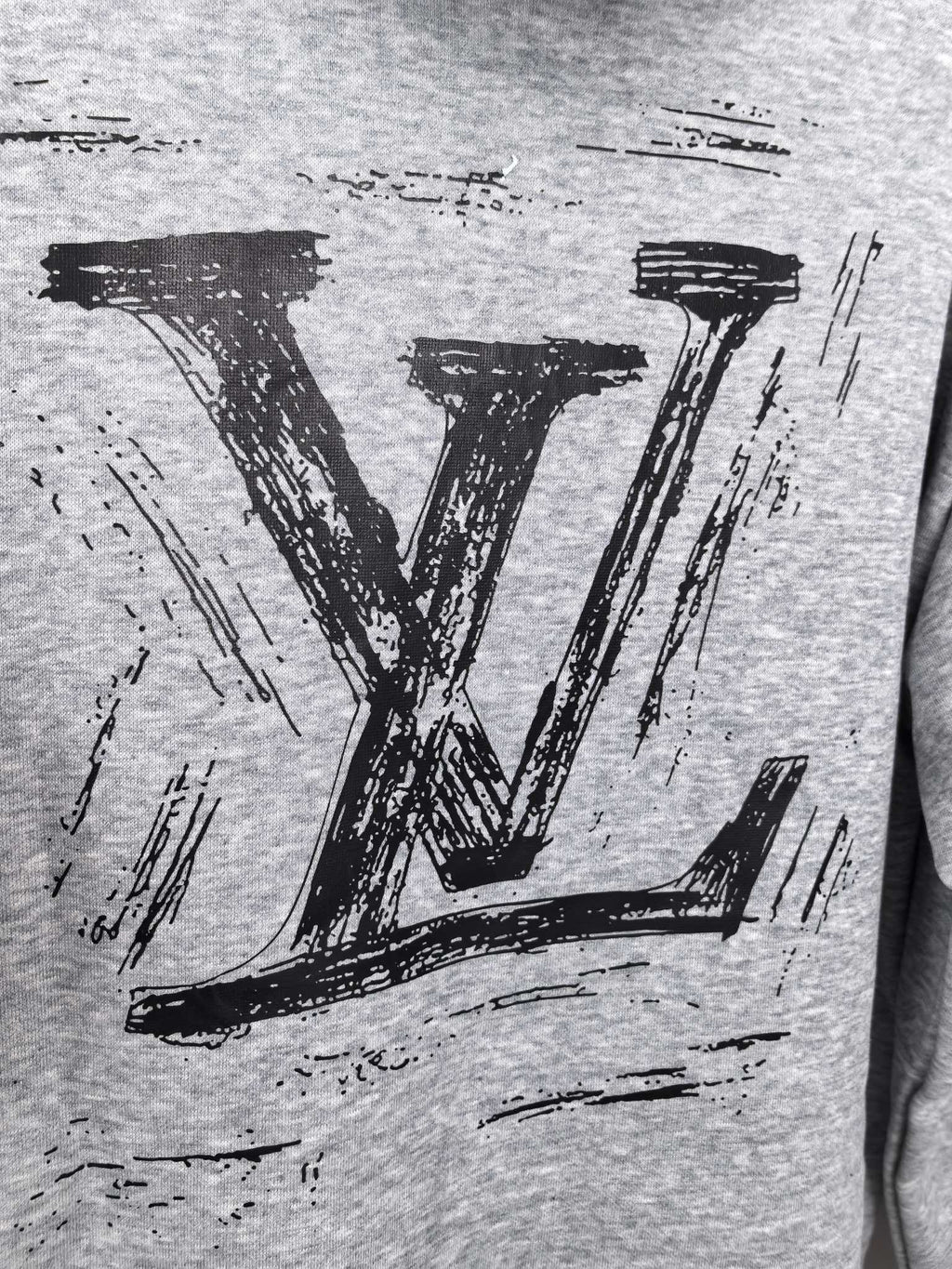 Heather gray hoodie close-up of bold black LV logo print
