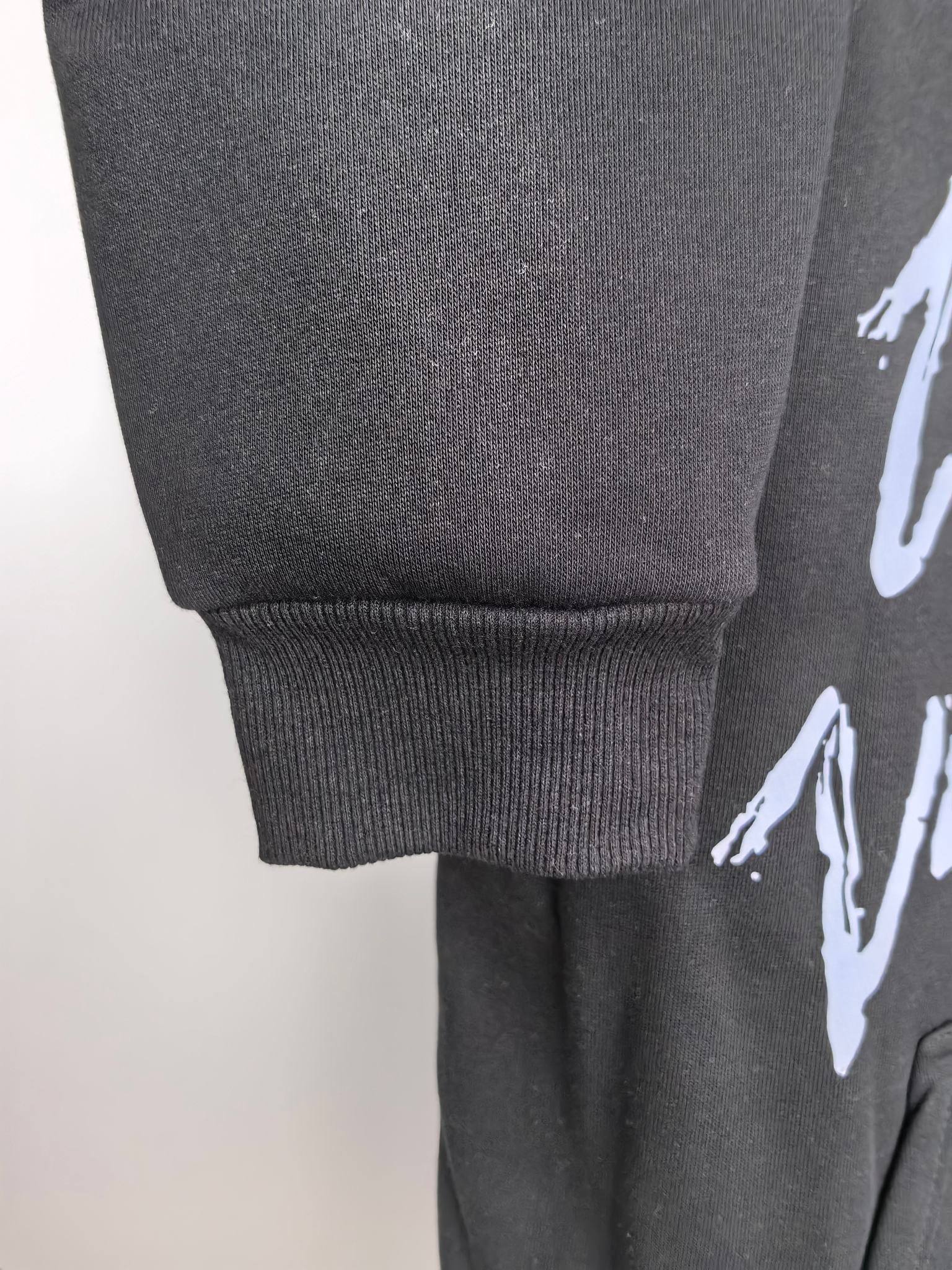 Dark gray hoodie cuff and hem with ribbed knit and side graphic print