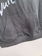 Dark gray hoodie kangaroo pocket with white graphic logo detail