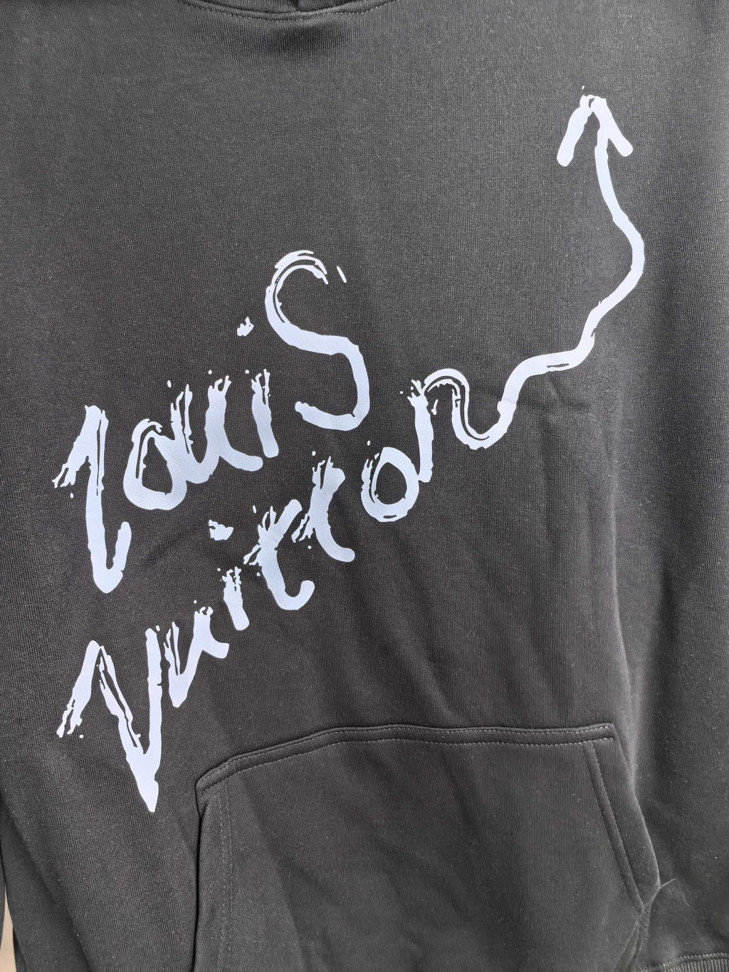 Dark gray hoodie chest graphic logo in white paint-style lettering