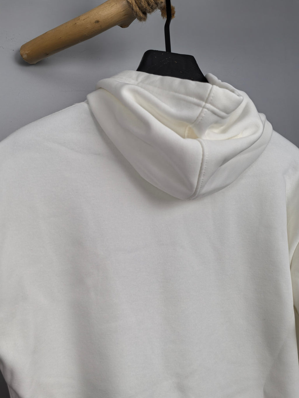 White hoodie with cowl-style hood and long sleeves, back view