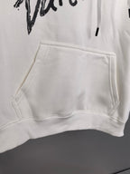 White hoodie front kangaroo pocket with ribbed hem and black graphic above