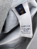 Gray hoodie fabric tag showing 'Made in Italy' and care symbols