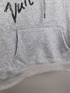 Gray hoodie front with kangaroo pocket, drawstring hood, and black script print