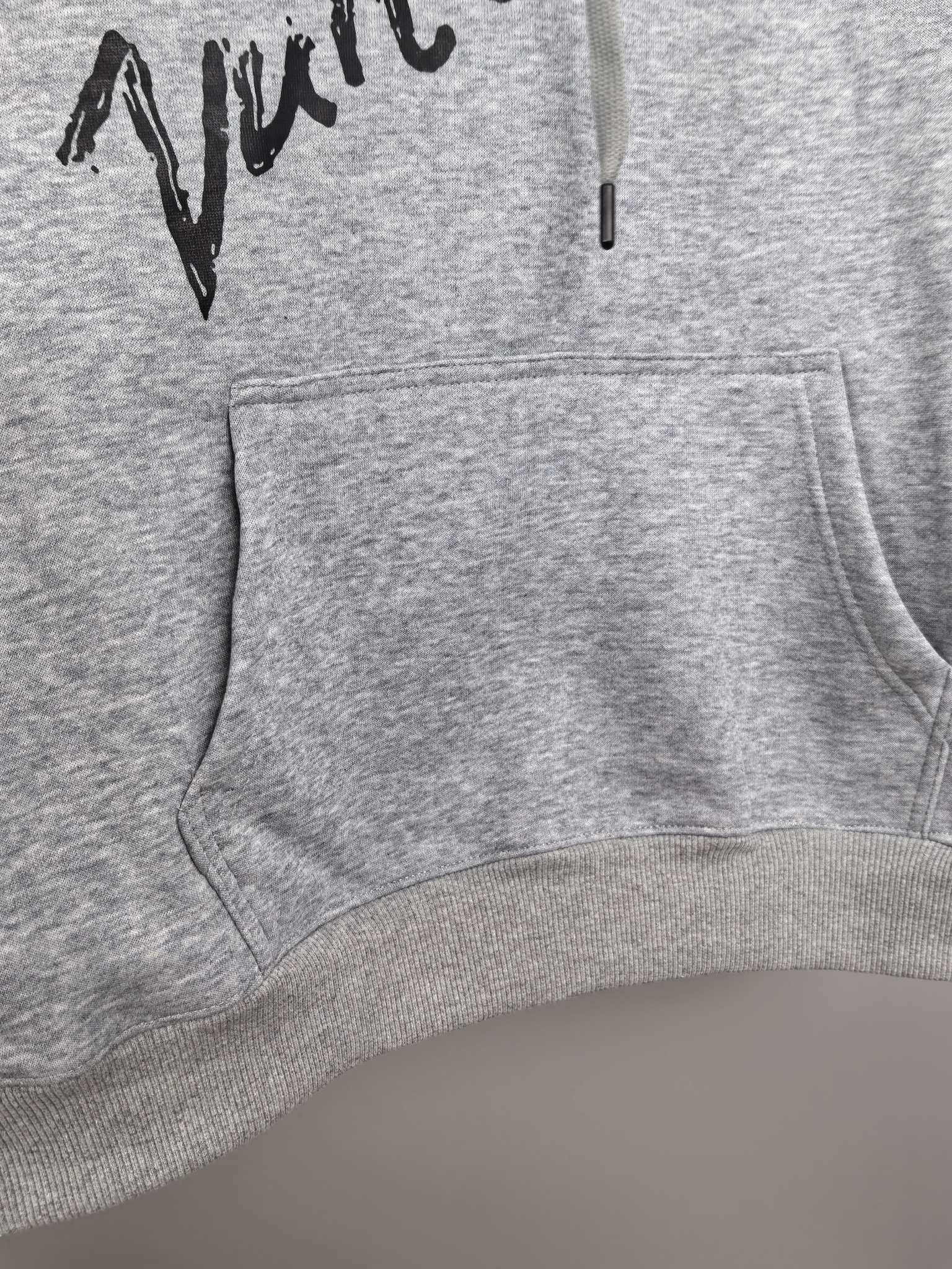 Gray hoodie front with kangaroo pocket, drawstring hood, and black script print