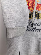 Gray hoodie sleeve and cuff with drawstring pocket area and Louis Vuitton print