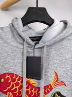 Gray hoodie close-up of hood drawstrings and Louis Vuitton fish graphic