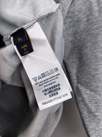 Gray hoodie interior tag marked “XL” and made in Italy