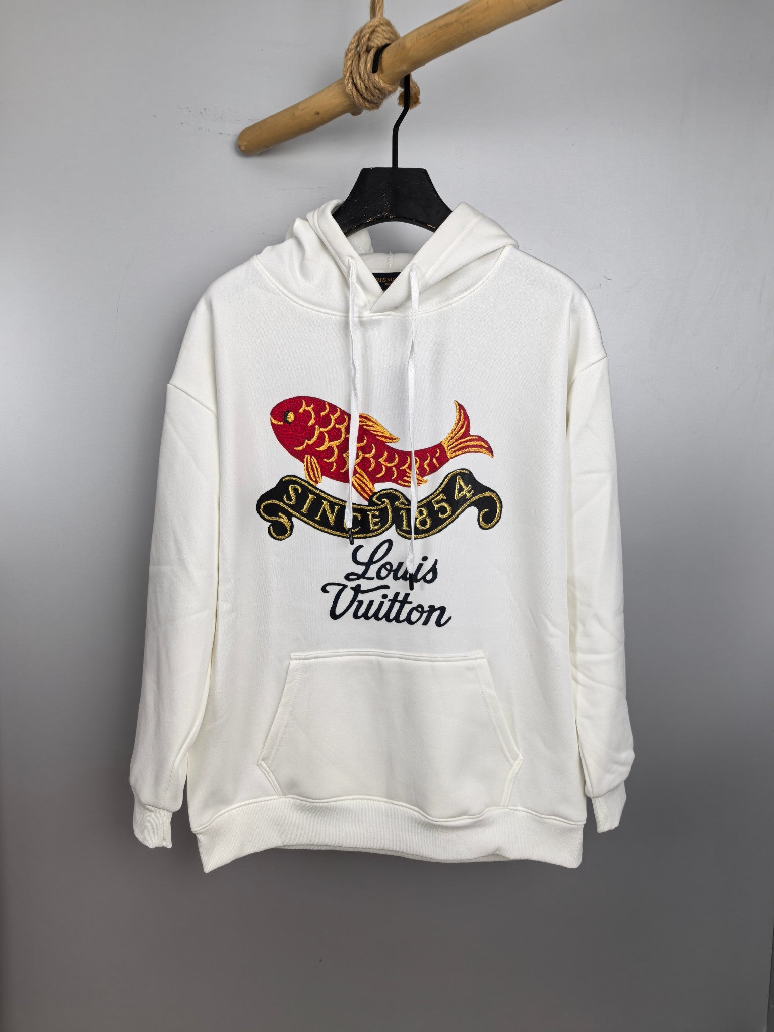 White long-sleeve hoodie with hood and colorful fish graphic, Louis Vuitton text on chest