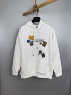 White Louis Vuitton hoodie with front hood, drawstrings, and logo patch graphics