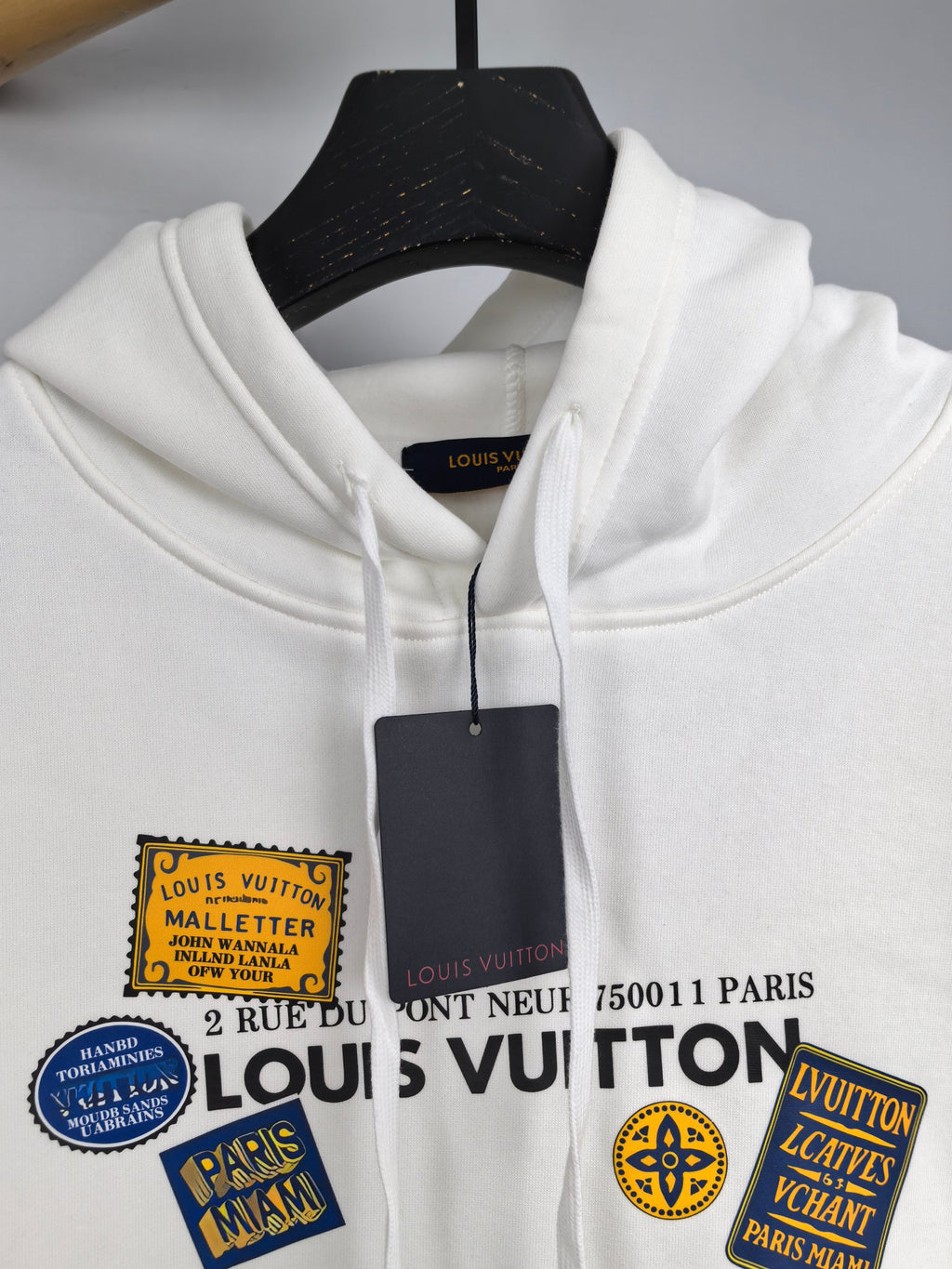 White Louis Vuitton hoodie hood with front logo patch graphic and drawstrings