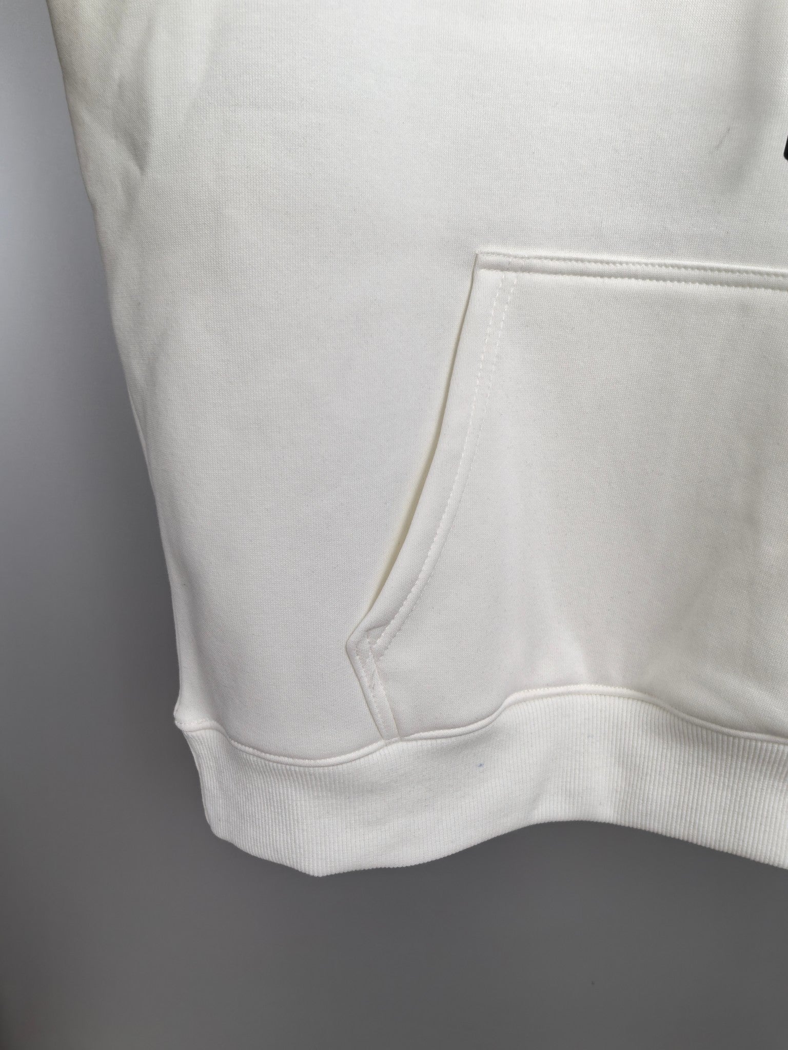 White Louis Vuitton hoodie hem with kangaroo pocket and ribbed trim