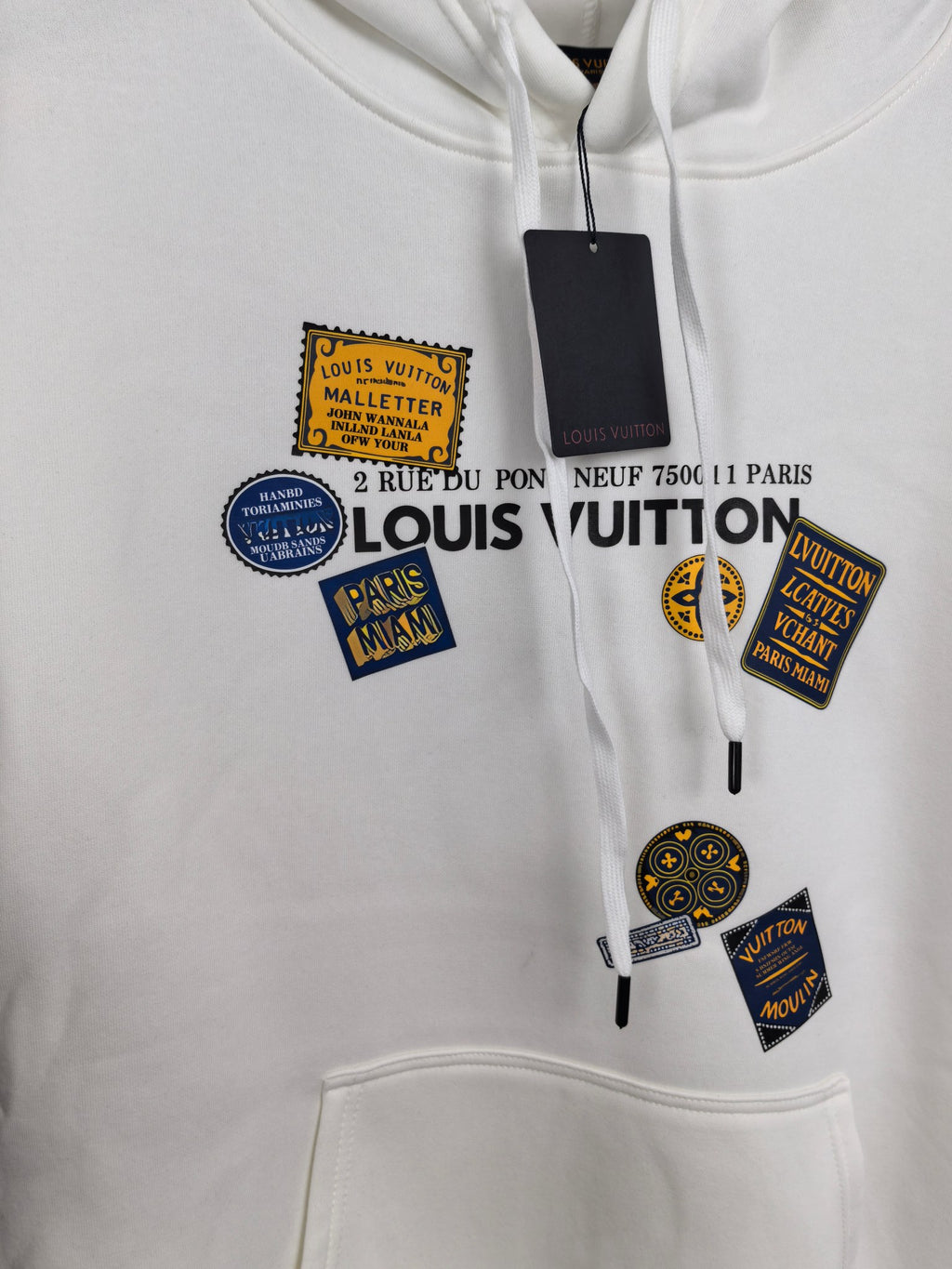 White Louis Vuitton hoodie front with multiple logo patch graphics and drawstrings
