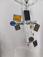 White Louis Vuitton hoodie front with multiple logo patch graphics and drawstrings