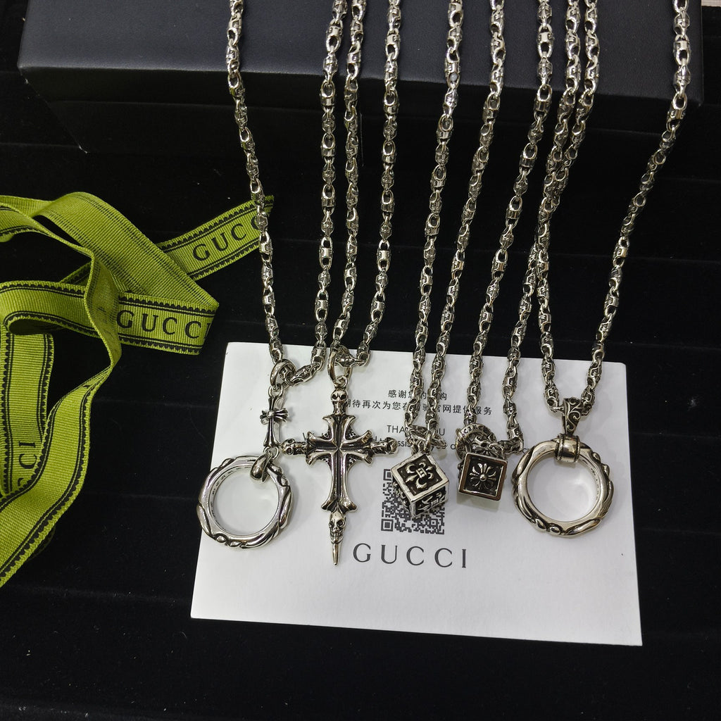 Silver-tone charm necklace set with ring, cross, and tag charms on chain links