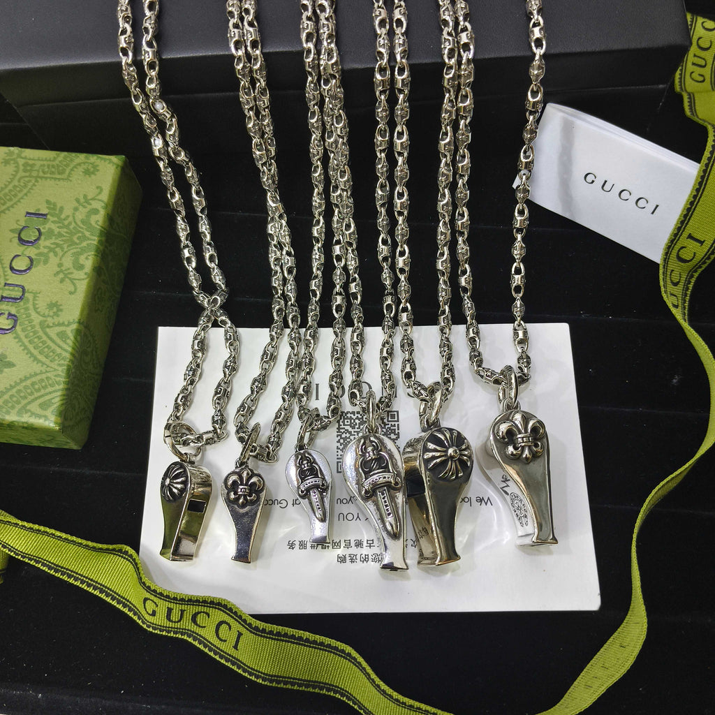 Silver-tone charm necklace set with small lock and key pendants on chain links
