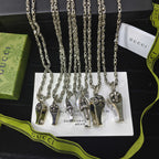 Silver-tone charm necklace set with small lock and key pendants on chain links