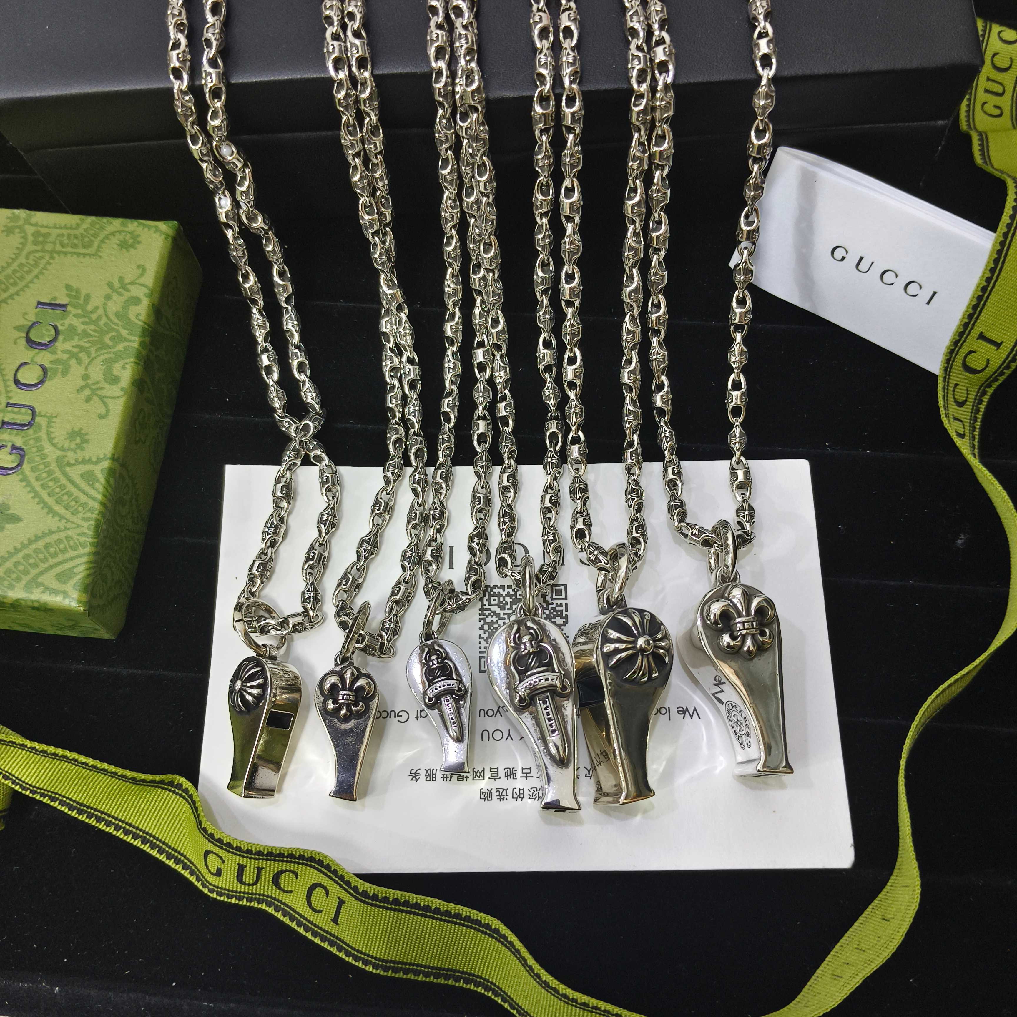 Silver-tone charm necklace set with small lock and key pendants on chain links