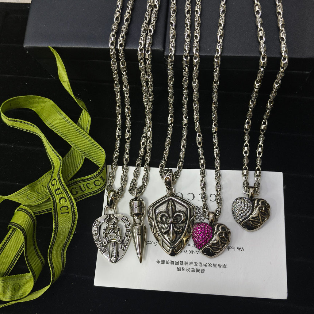 Silver-tone charm necklace set with spade, key, and heart charms plus purple accent bead