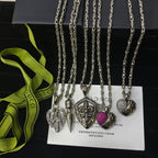 Silver-tone charm necklace set with spade, key, and heart charms plus purple accent bead