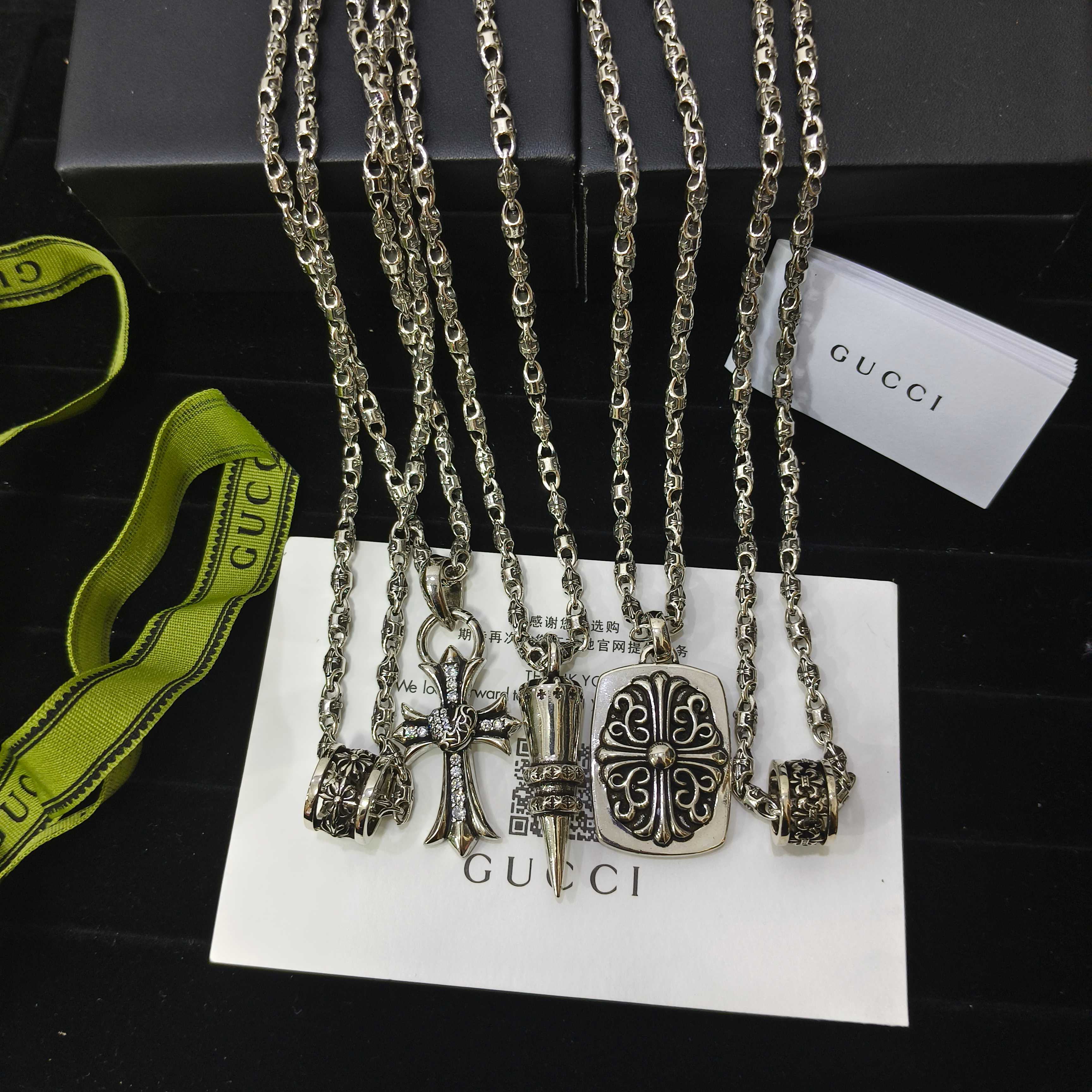 Silver-tone charm necklace set with handbag and bow charms on chain links