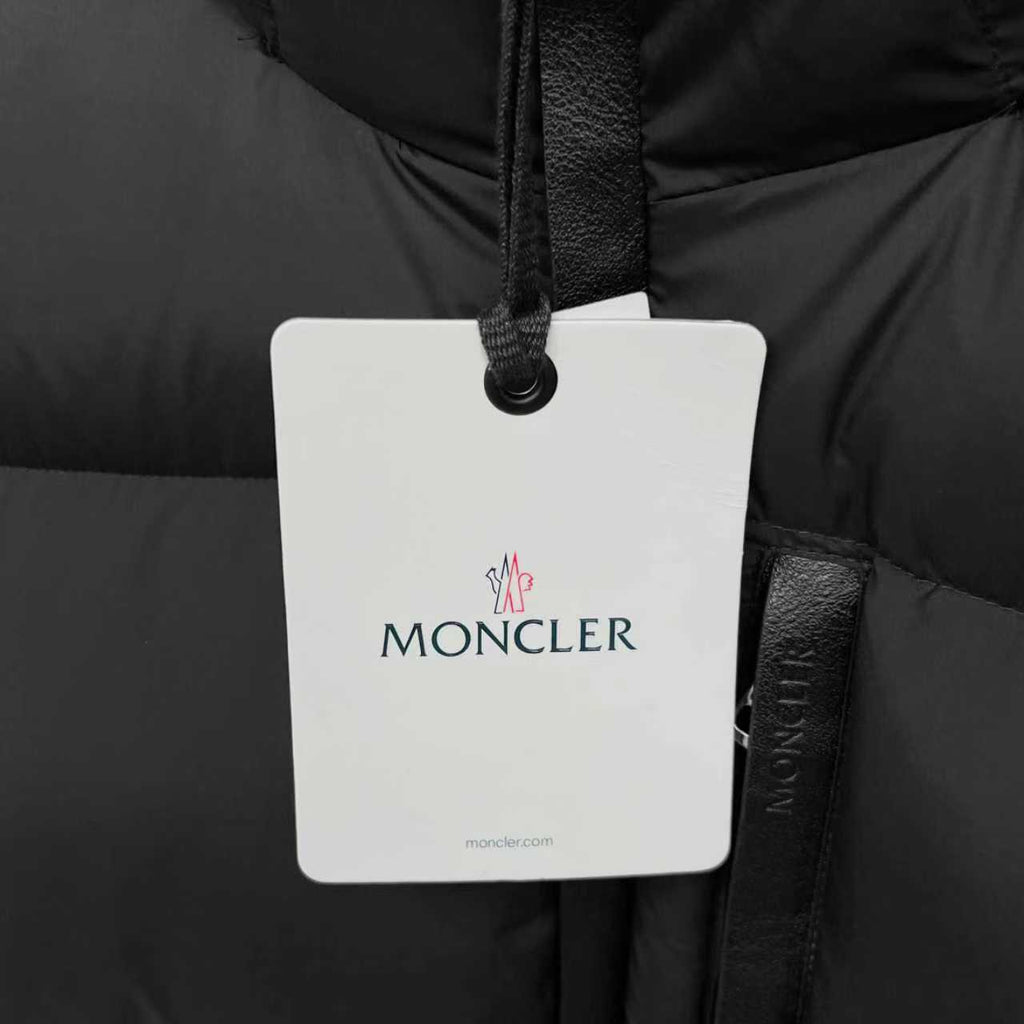 Moncler logo hang tag on black puffer jacket