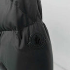 Black puffer jacket sleeve with embossed Moncler patch