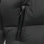 Black puffer jacket detail, front zipper placket and quilted stitching