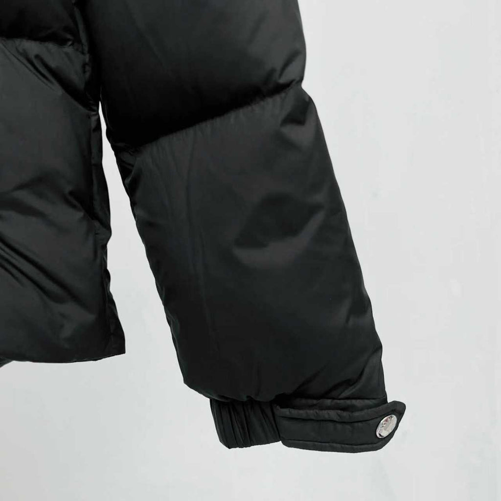 Black puffer jacket sleeve cuff with elastic trim