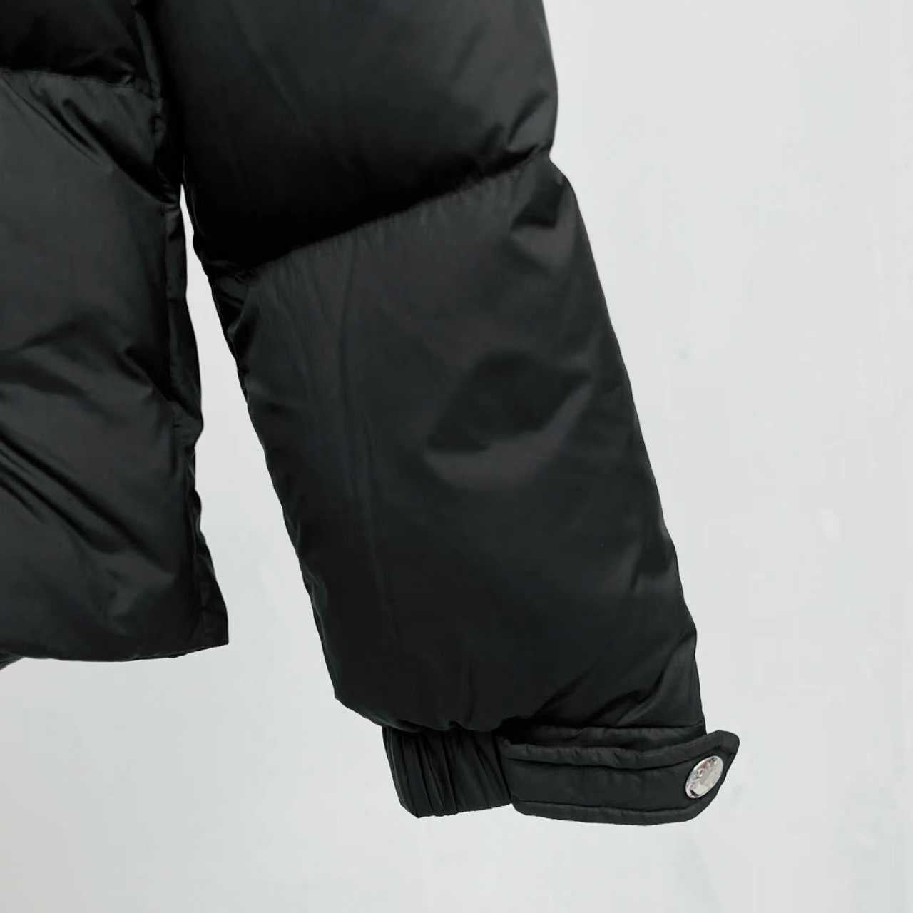 Black puffer jacket sleeve cuff with elastic trim