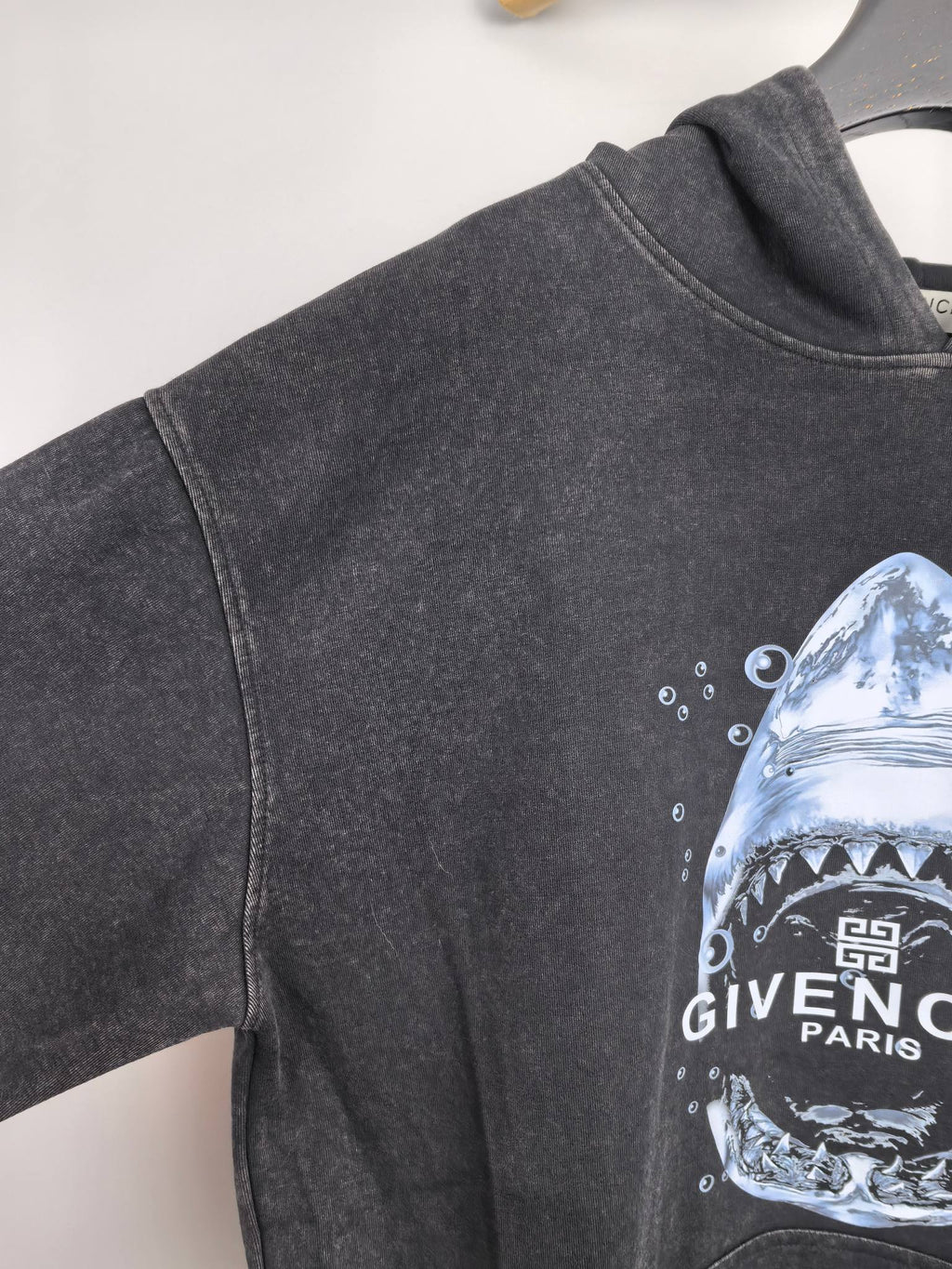 Givenchy charcoal hoodie side view with partial shark graphic on the sleeve
