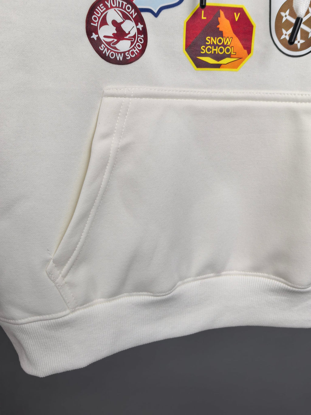 White Louis Vuitton hoodie with kangaroo pocket and partial logo patches