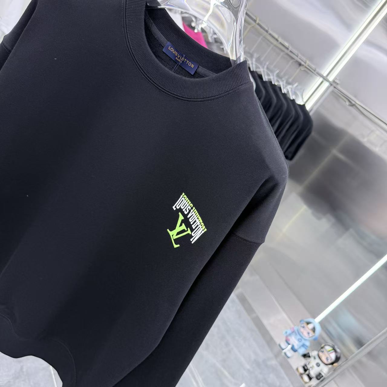 Black Louis Vuitton crewneck sweatshirt close-up of neon chest logo