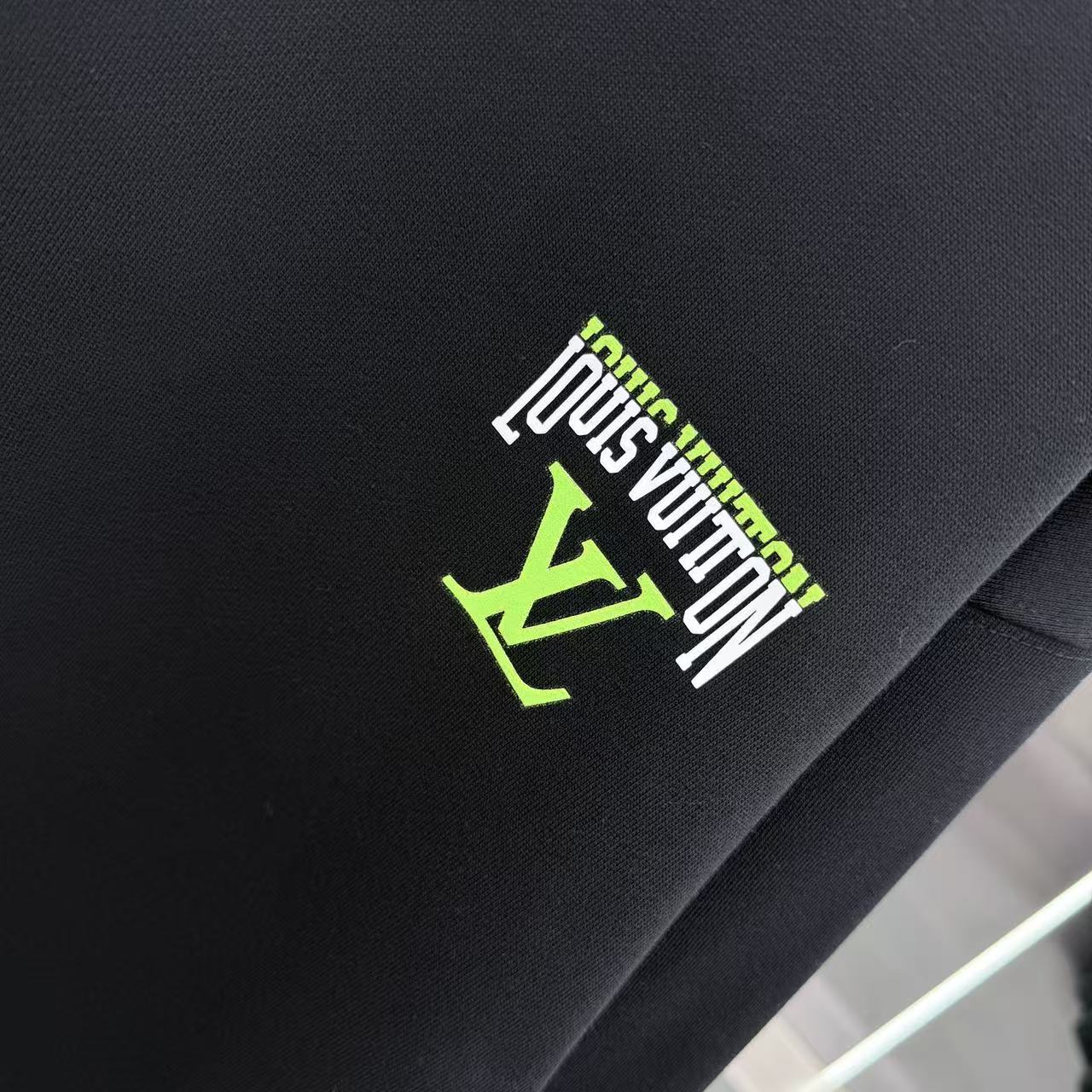 Black Louis Vuitton logo patch in green and white on sweatshirt