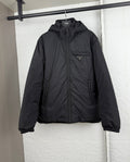 Prada hooded puffer jacket, dark black, front view with full zipper