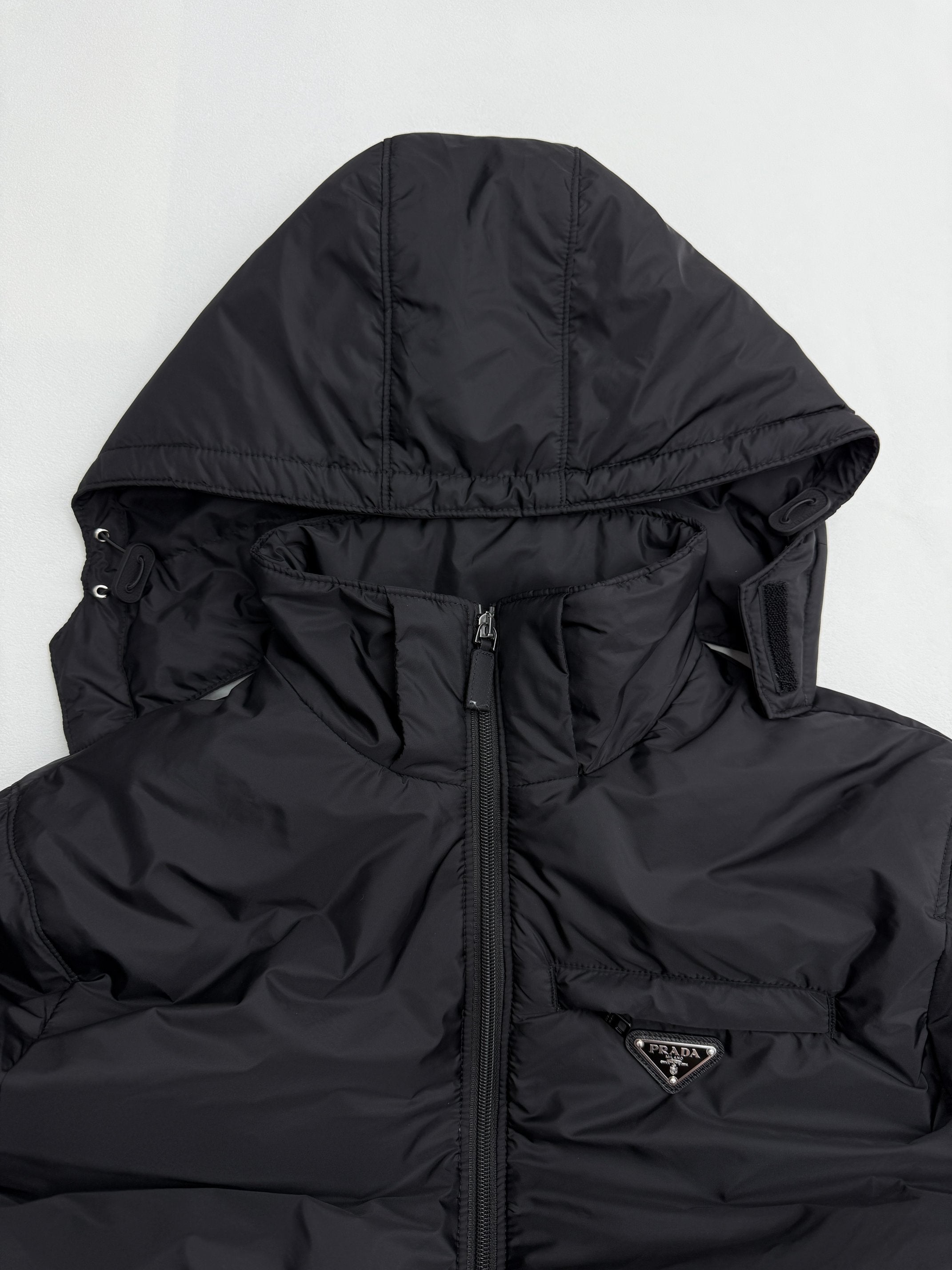 Prada hooded puffer jacket, close-up of hood and front zipper