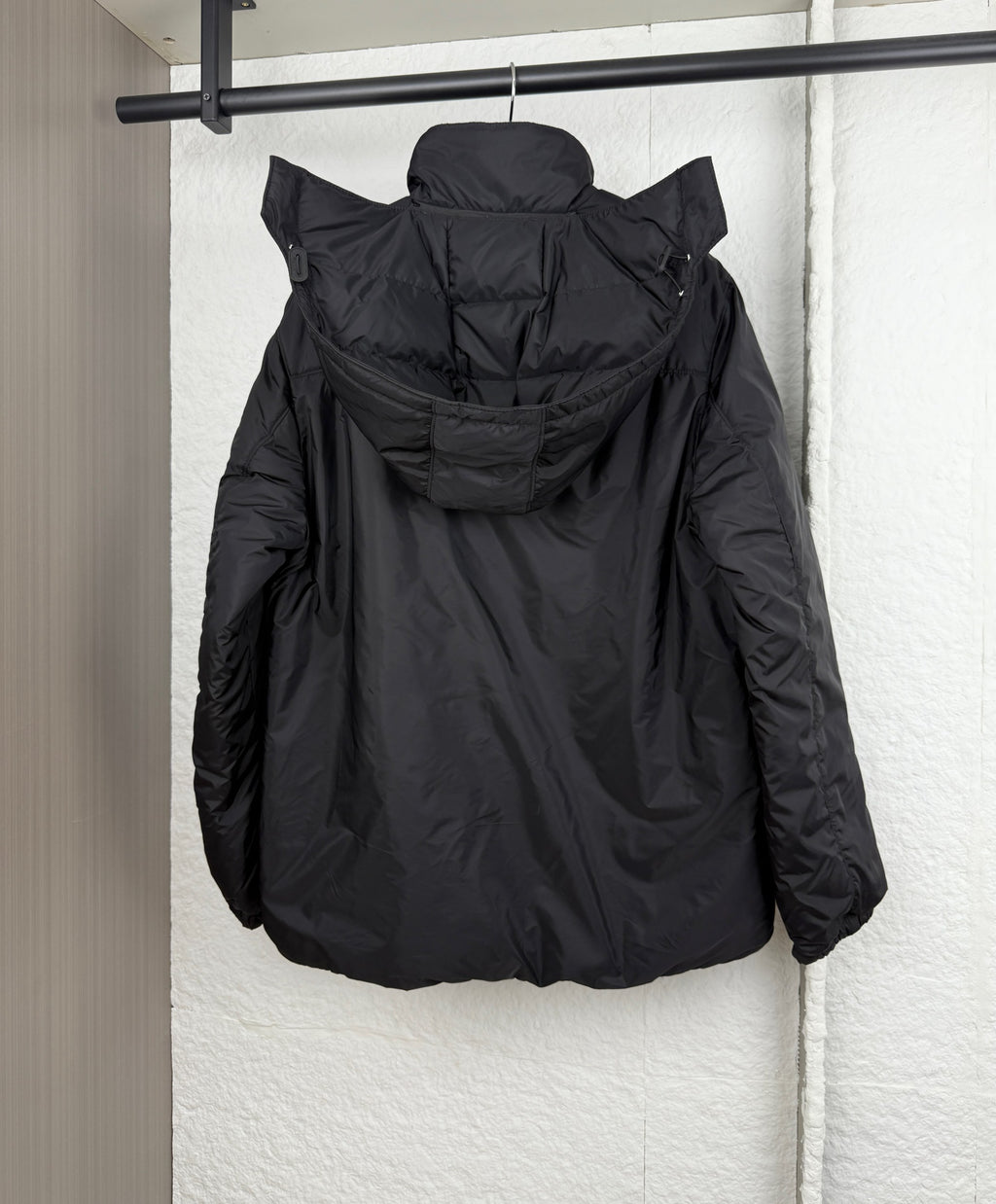 Prada hooded puffer jacket, dark black, back view with hood and zipper