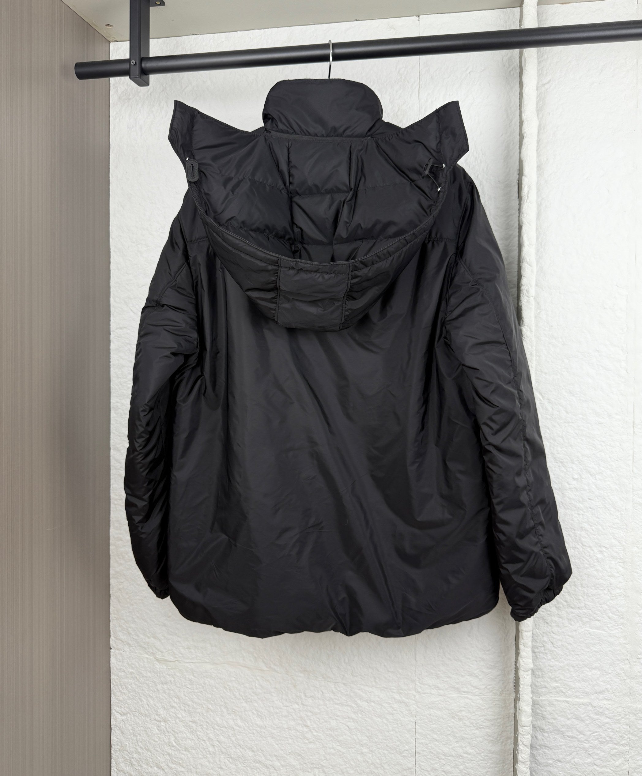 Prada hooded puffer jacket, dark black, back view with hood and zipper