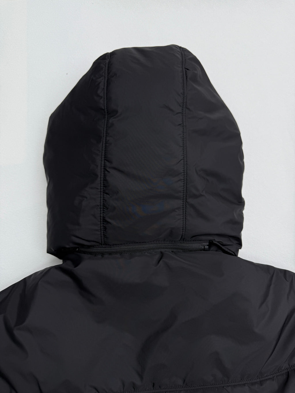 Prada hooded puffer jacket back view with hood, dark black