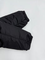 Prada puffer jacket sleeve cuff, dark black, angled close-up