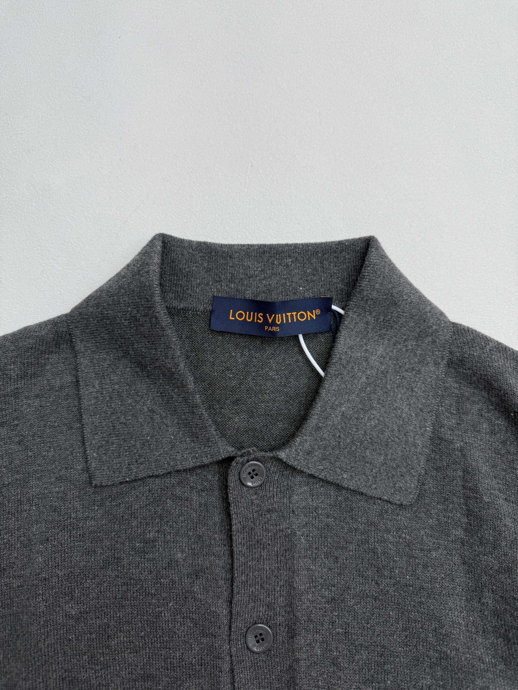 Heather gray polo shirt collar and button placket with Louis Vuitton neck label