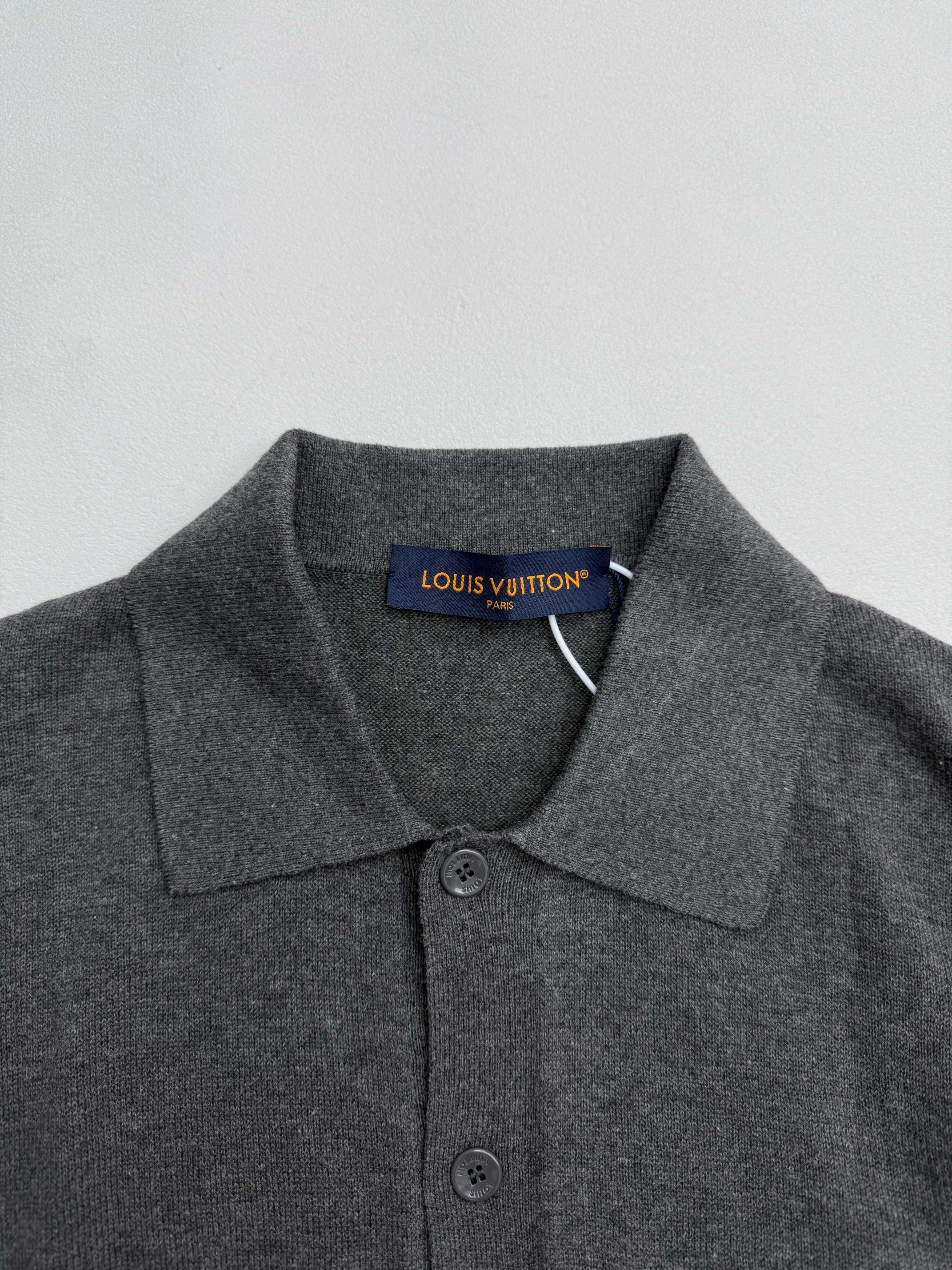 Heather gray polo shirt collar and button placket with Louis Vuitton neck label