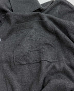 Heather gray polo shirt chest pocket with knit texture and button detail
