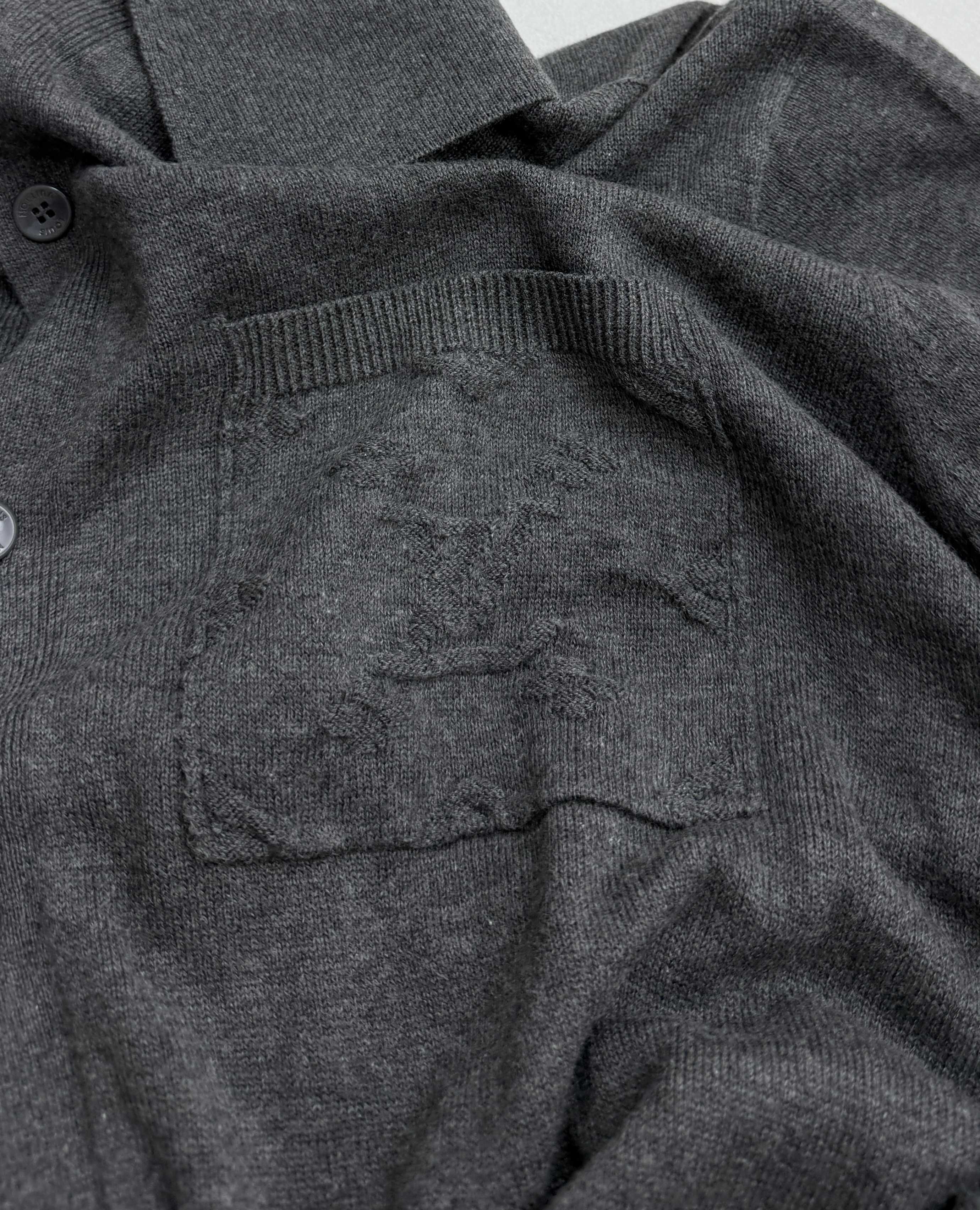 Heather gray polo shirt chest pocket with knit texture and button detail
