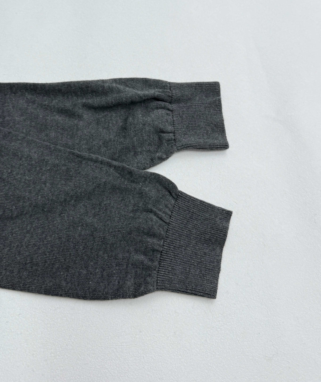 Heather gray long-sleeve polo shirt cuff and sleeve hem, laid flat