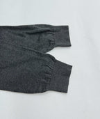 Heather gray long-sleeve polo shirt cuff and sleeve hem, laid flat