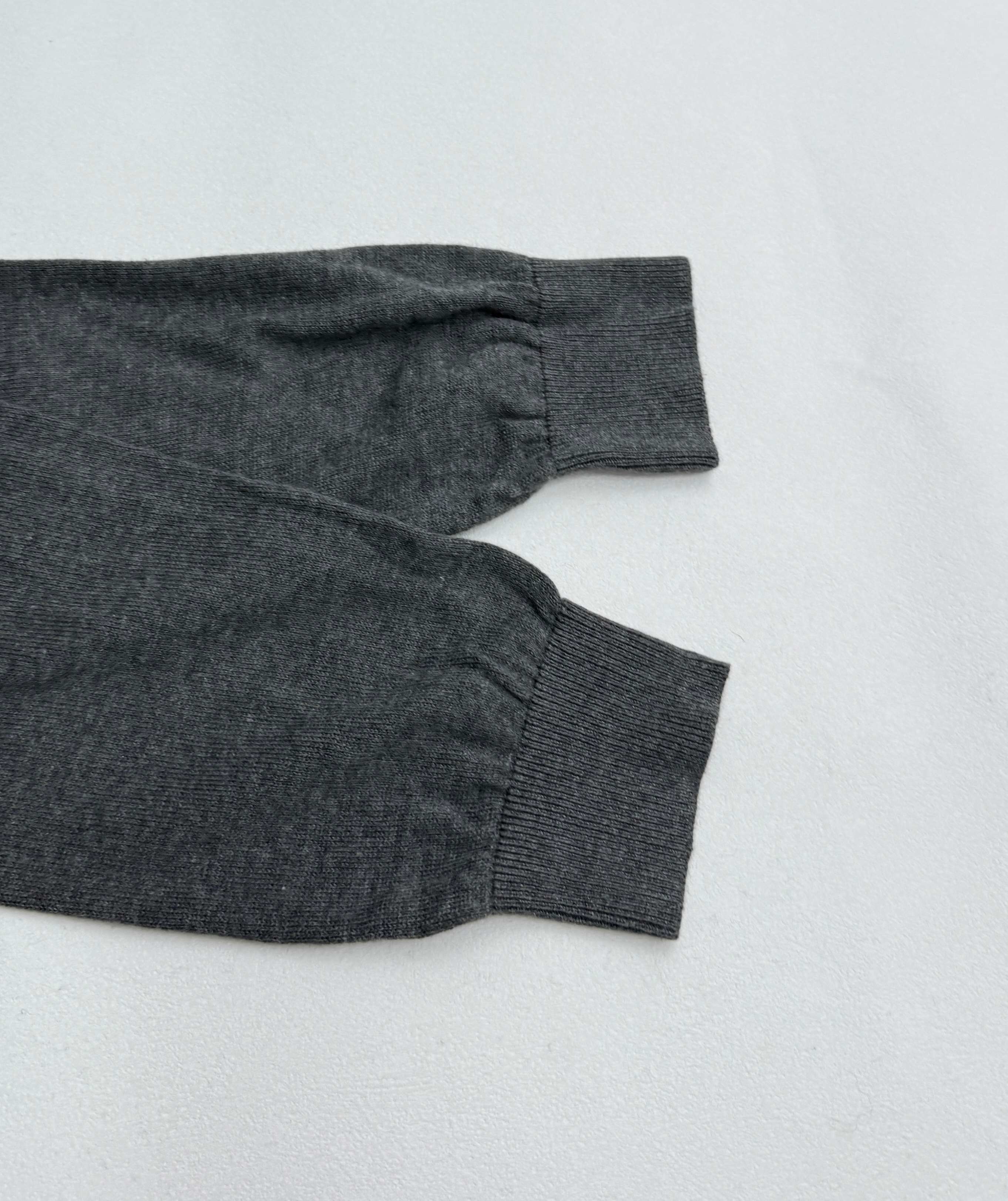 Heather gray long-sleeve polo shirt cuff and sleeve hem, laid flat