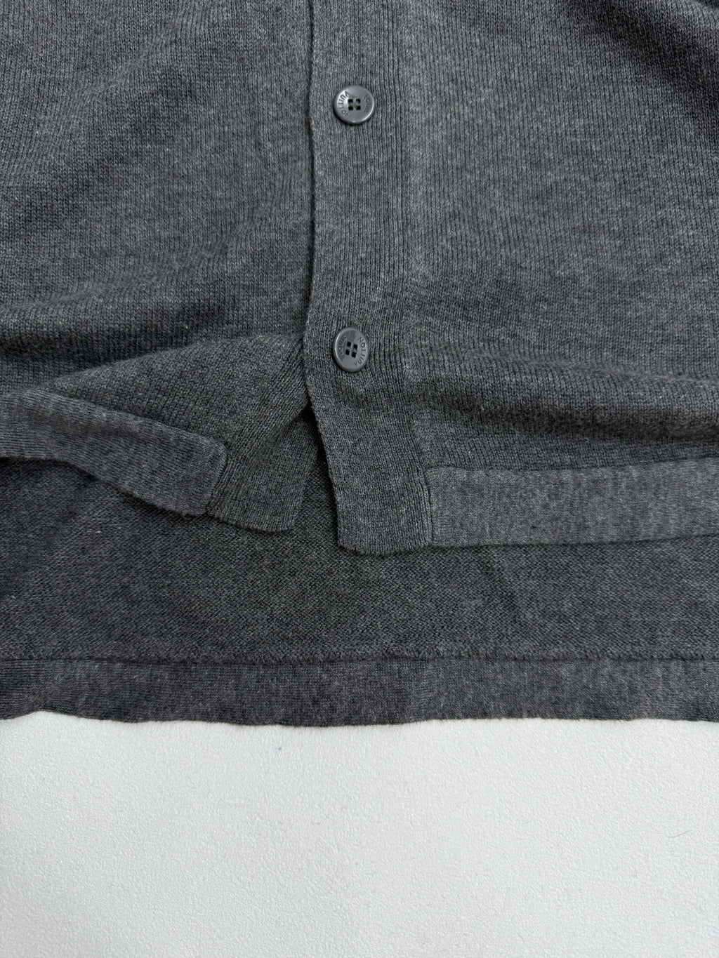 Heather gray polo shirt lower placket with two buttons and side pocket